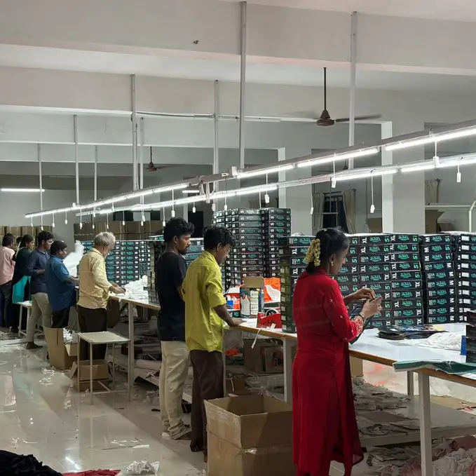 Quality assurance team inspecting and boxing products in a bulk corporate packaging line