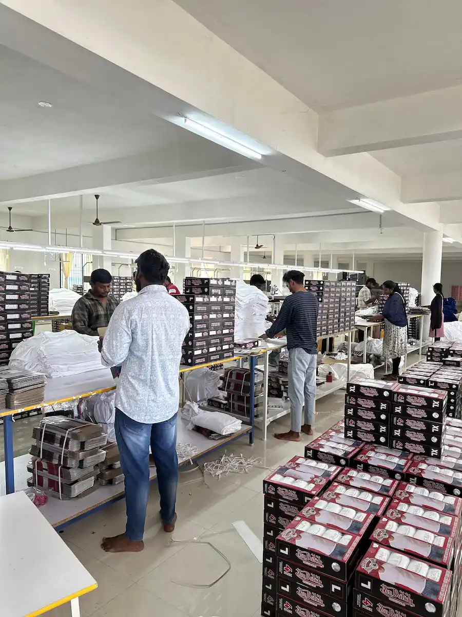 Production line workers packing customized retail gift boxes for corporate clients