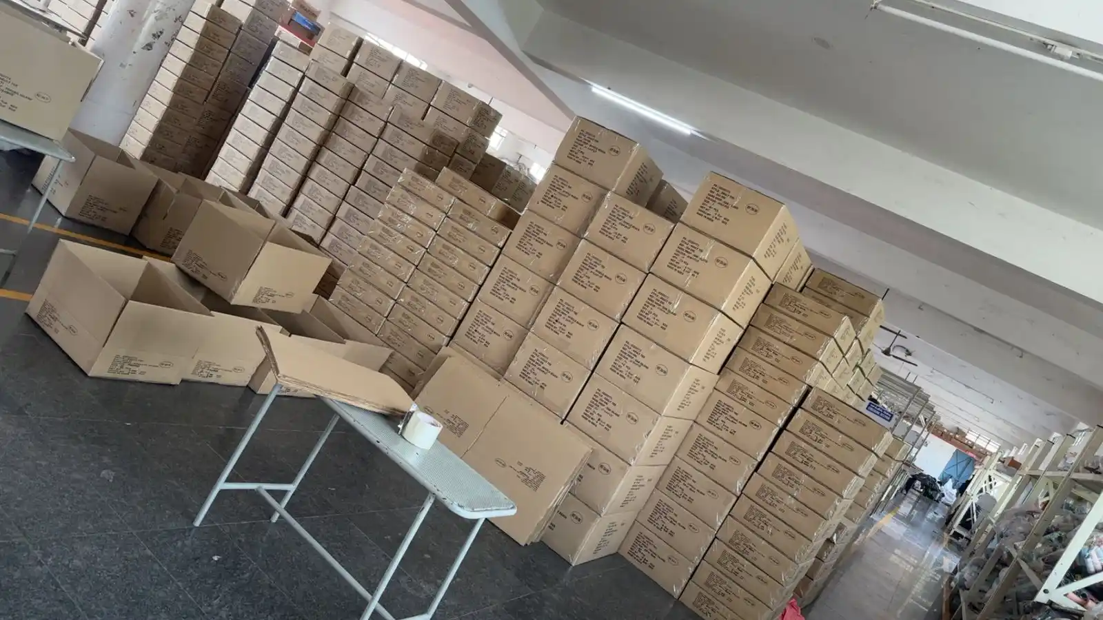 High volume dispatch cartons stacked in a multi-level corporate merchandise warehouse