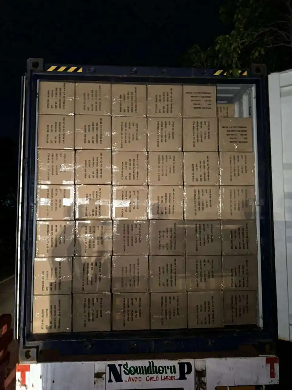 Fully loaded shipping container tightly packed with B2B corporate apparel cargo boxes