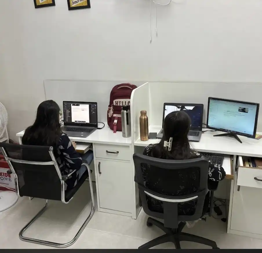 K.K. Exports India office workstation setup with employees working on laptops