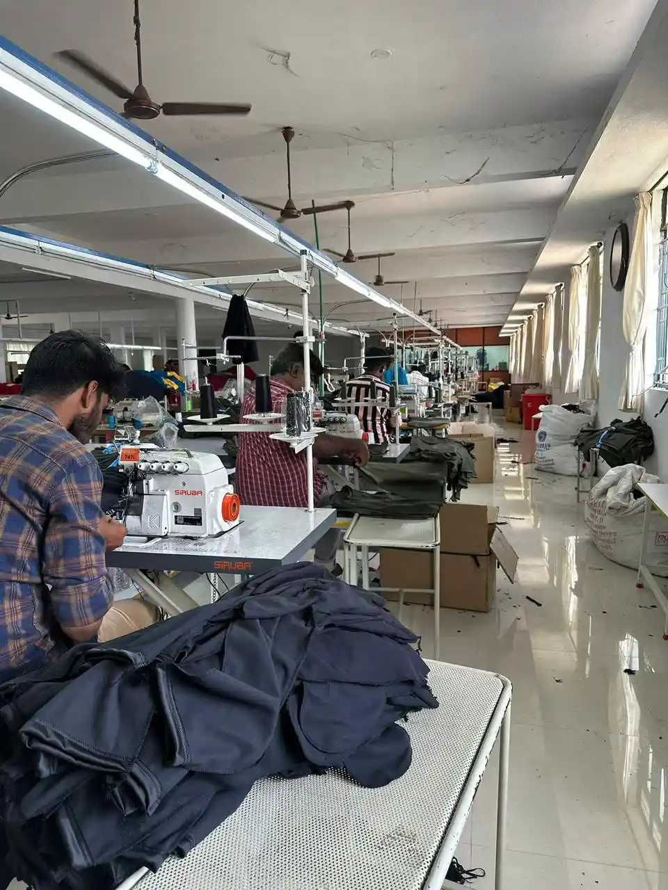 Production floor cutting and stitching dark executive formal wear for corporate gifting hampers