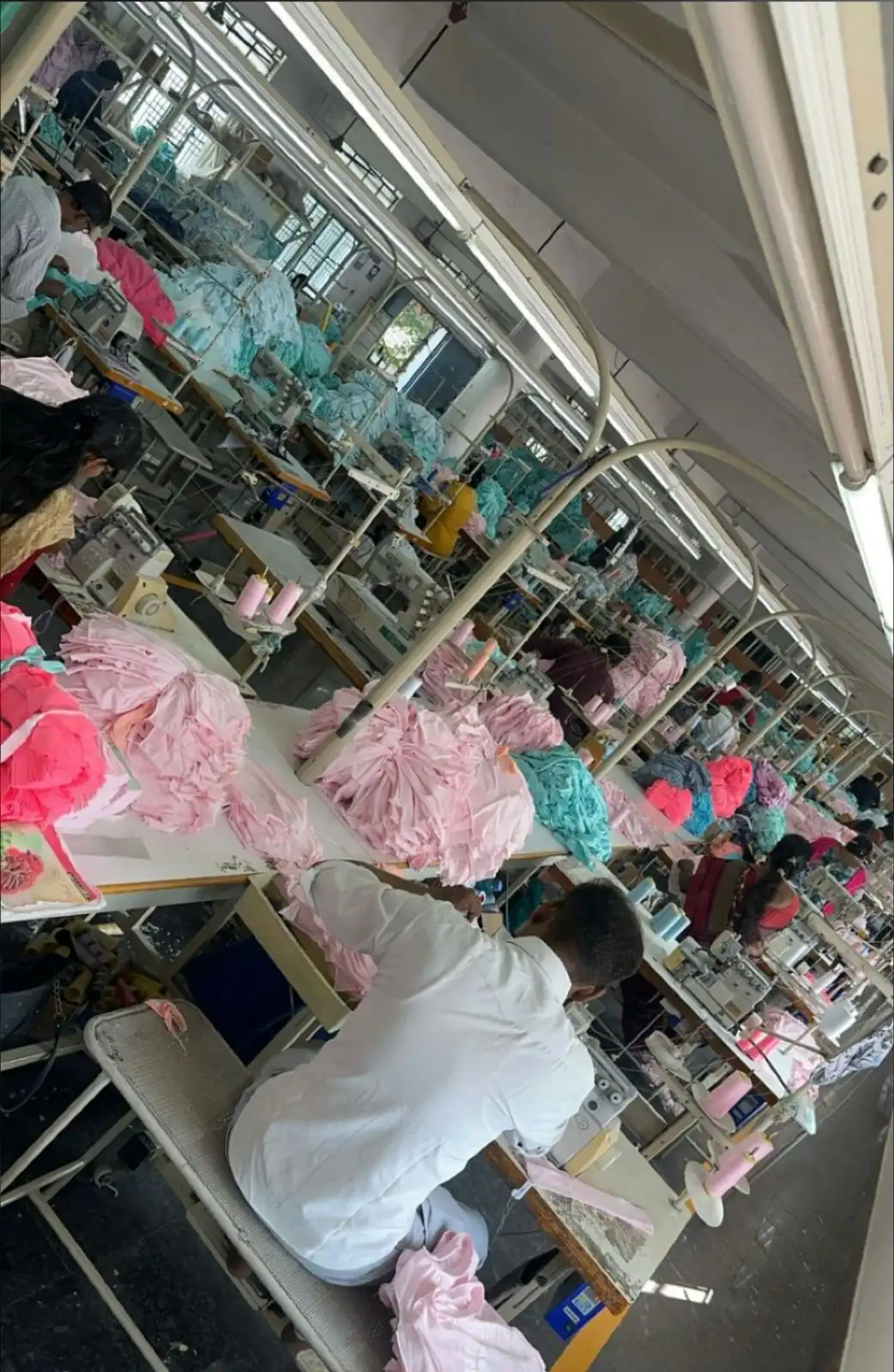 Overhead view of large scale industrial stitching line manufacturing customized corporate merchandise